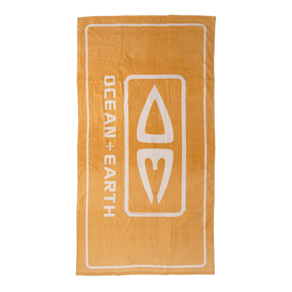 Ocean & Earth Priority Beach Towel: Gold logo beach towel laid flat