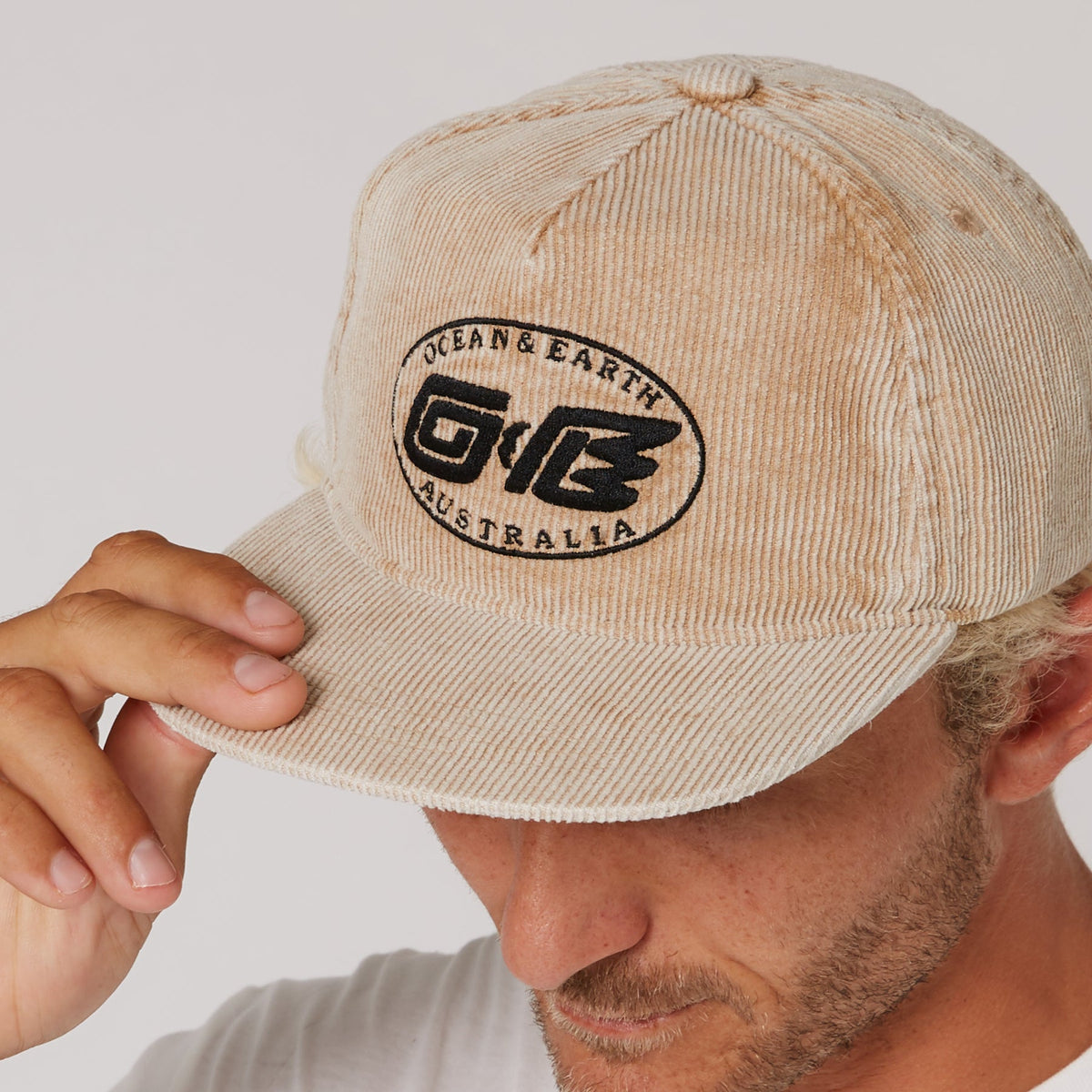Ocean & Earth Heritage Cap: Almond cap brim and logo close-up