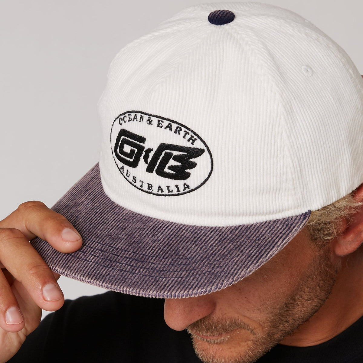 Ocean & Earth Heritage Cap: Antique White cap worn, close-up