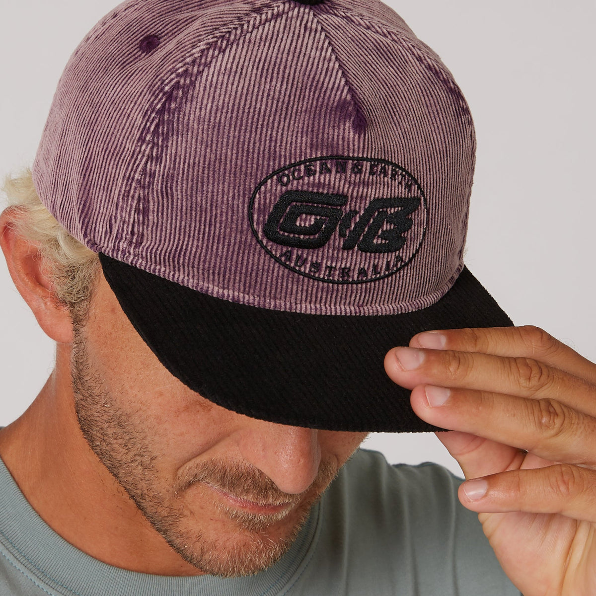 Ocean & Earth Heritage Cap: Plum cap brim and logo close-up