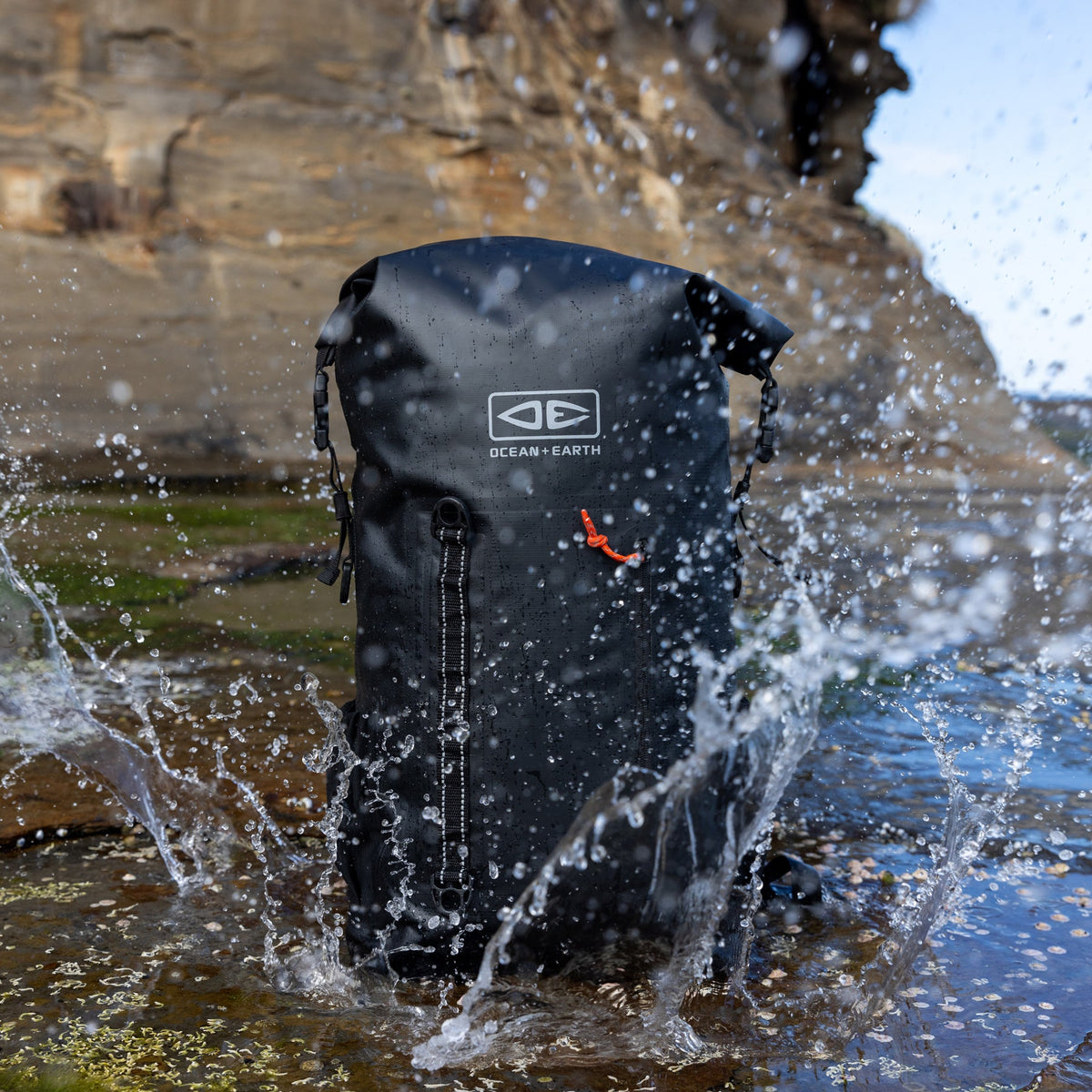 Ocean & Earth Elements 40 L Wetsuit Bag: waterproof bag splashed on rocks