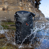 Ocean & Earth Elements 40 L Wetsuit Bag: waterproof bag splashed on rocks