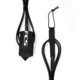 FCS Classic All Round Leash: black leash coiled beside the ankle cuff