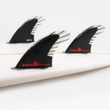 FCS II Accelerator Tri Fins - PC Carbon + AirCore: black and red carbon thruster fins installed on a surfboard