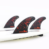 Filipe Toledo black and red thruster set mounted on a white surfboard in the studio
