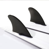 Black Modern Keel pair mounted on a white surfboard