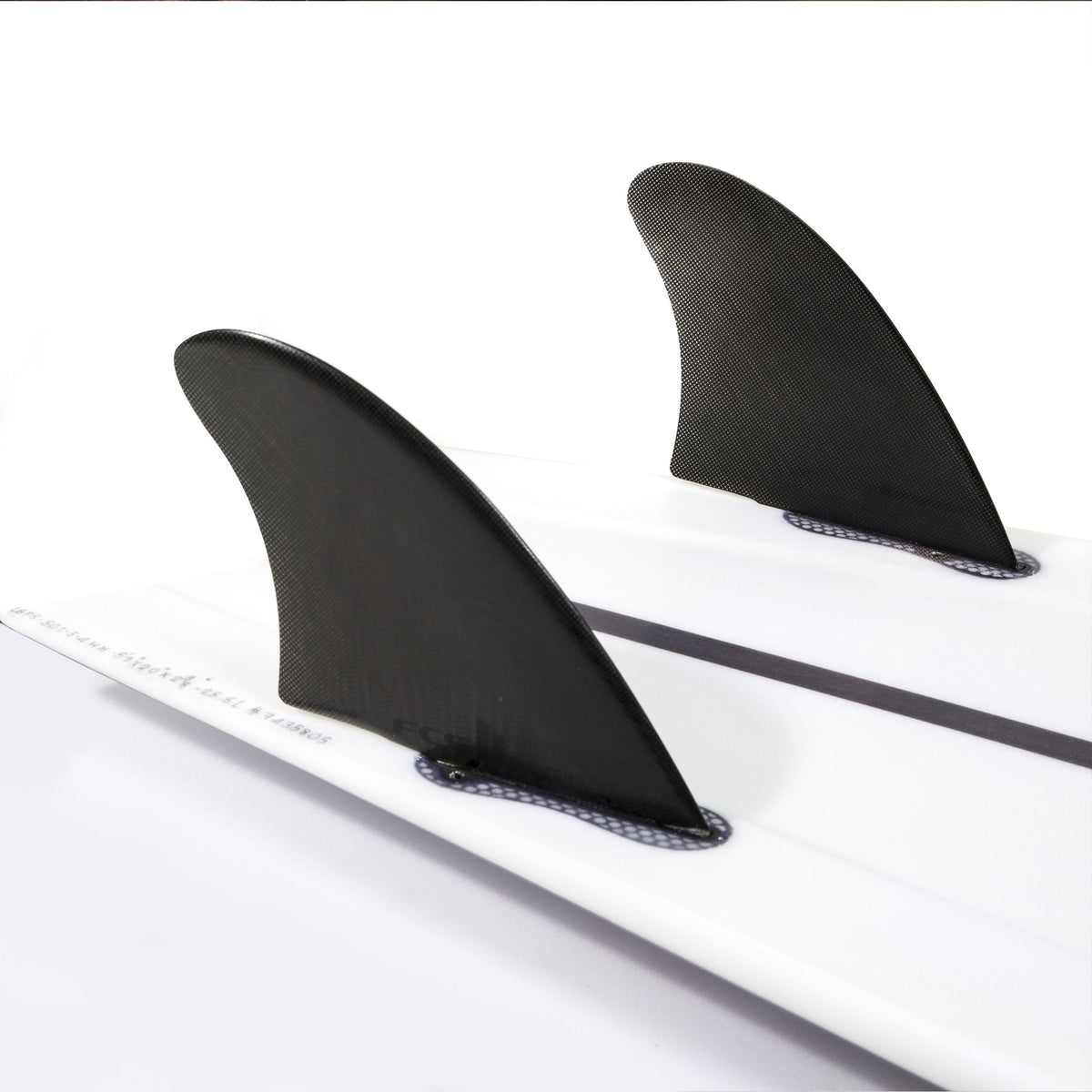 Black Modern Keel pair mounted on a white surfboard