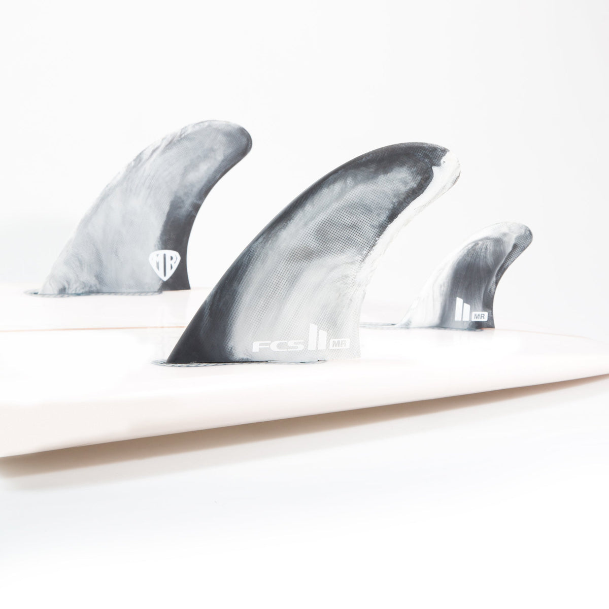 Mark Richards twin fins and centre stabiliser fitted to a white surfboard in the studio