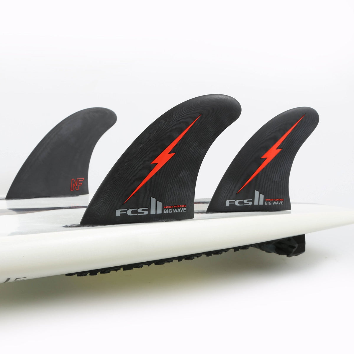 Nathan Florence Big Wave thruster set mounted on a white surfboard