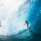Surfer riding inside a large breaking blue wave in the Nathan Florence gallery
