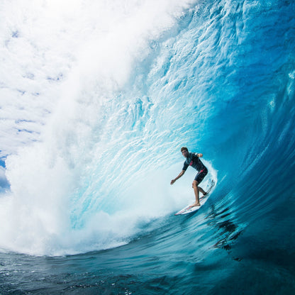 Surfer riding inside a large breaking blue wave in the Nathan Florence gallery