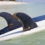 Album twin fins and stabiliser mounted on a surfboard at the water surface