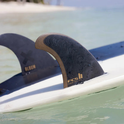 Album twin fins and stabiliser mounted on a surfboard at the water surface
