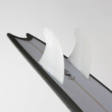 FCS II Mick Fanning Twin + Stabiliser Fins - PC + AirCore: white twin and stabiliser mounted on a board at an angle