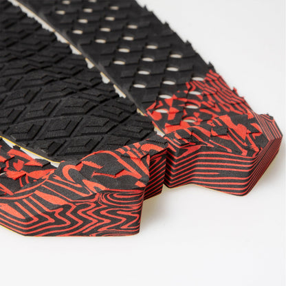 FCS Filipe Toledo Traction: close detail of red kick artwork and perforated black foam