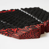 FCS Filipe Toledo Traction: low angle view of the red and black tail kick behind the textured foam