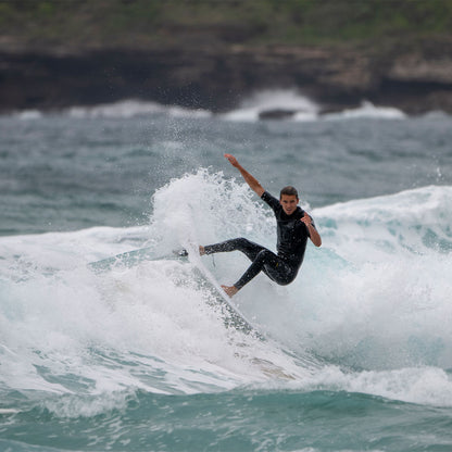 FCS II Al Merrick Twin + Stabiliser Fins - Performance Core: surfer carving a small coastal wave