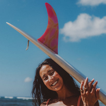 FCS II Kelia Moniz Longboard Fin - Performance Glass: kelia carrying a board fitted with the Sunset Glass fin