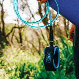 Ocean & Earth Diamond Flex Regular Leash – 8 ft: Blue leash carried beside a board