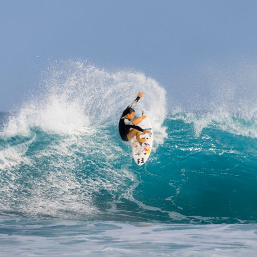 FCS II Sky Brown Tri Fins - Performance Core: sky Brown performing a turn on an open blue wave