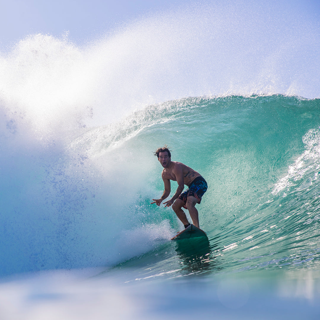 FCS II Mason Ho Tri Fins - PC + AirCore: mason Ho riding inside a breaking blue wave