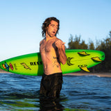 FCS II Mason Ho Tri Fins - PC + AirCore: mason Ho standing in the water with a bright green surfboard