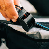 Ocean & Earth Surfboard Rap Rax – Single Stack: Cam buckle being tightened by hand