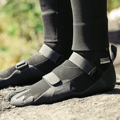 Ocean & Earth Bells 3 mm Split-Toe Booties: booties worn on a rocky shoreline