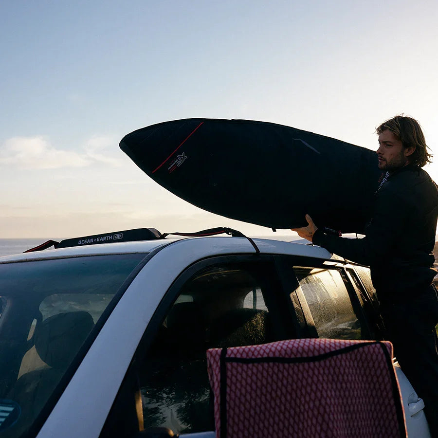 Ocean & Earth Surfboard Rap Rax – Single Stack: Surfer loading a board at sunset