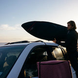 Ocean & Earth Surfboard Rap Rax – Single Stack: Surfer loading a board at sunset