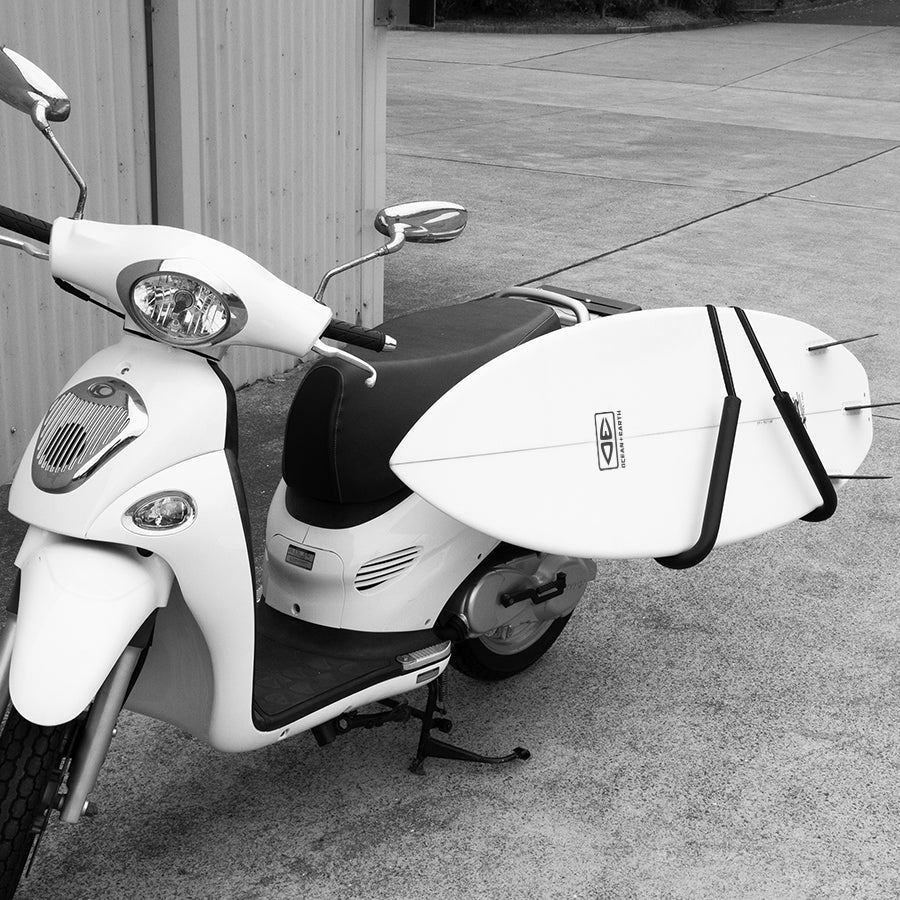 Ocean & Earth Moped & Scooter Surfboard Rack: Surfboard secured alongside a scooter, close view