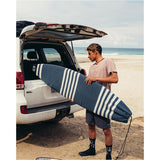 Ocean & Earth Stretch Shortboard Sock: shortboard sock carried beside a car