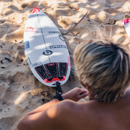 Ocean & Earth Kanoa Igarashi Signature Traction Pad: Kanoa pad fitted to a surfboard on the beach