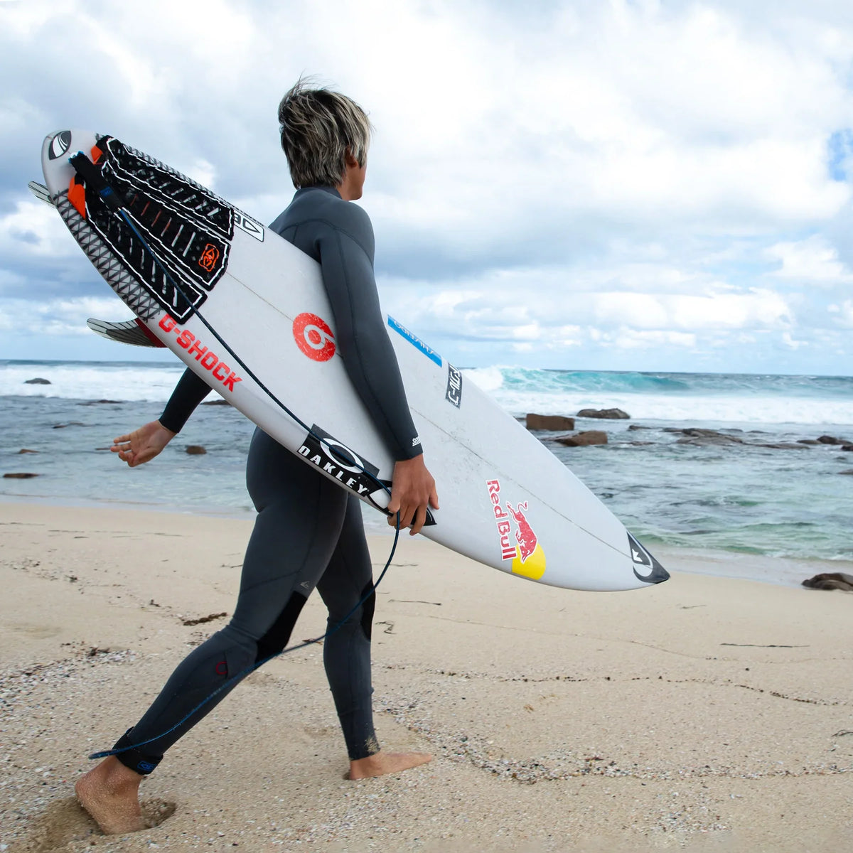Ocean & Earth Kanoa Igarashi Signature Traction Pad: surfer carrying a board with the pad fitted