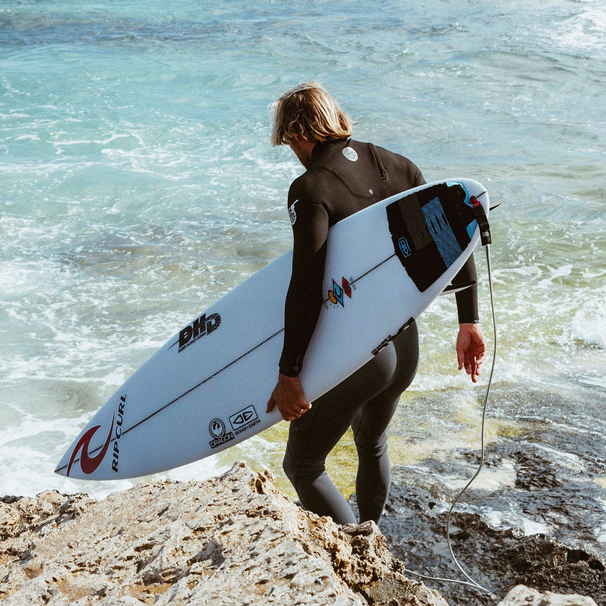 Ocean & Earth Owen Wright Pro Tail Pad: Owen Wright carrying a surfboard