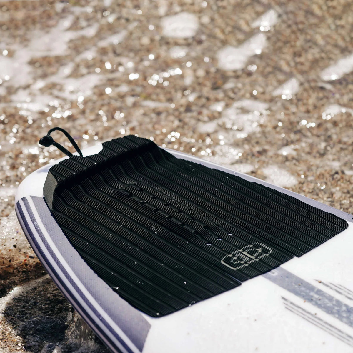Ocean & Earth Flight Three-Piece Traction Pad: pad fitted on a board at the beach
