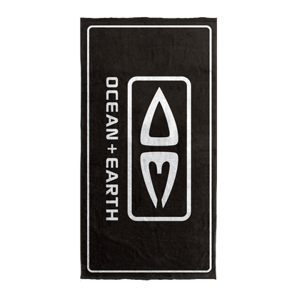 Ocean & Earth Priority Beach Towel: Black logo towel laid flat vertically