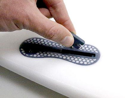 Hand inserting a compatibility infill into a surfboard fin box