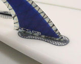 FCS dual tab fin fitted into a box with the compatibility infill