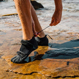 FCS SP2 Reef Boots: sP2 boots worn on wet rocks, close-up