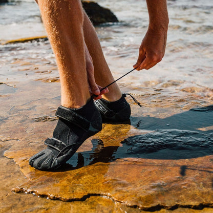 FCS SP2 Reef Boots: sP2 boots worn on wet rocks, close-up